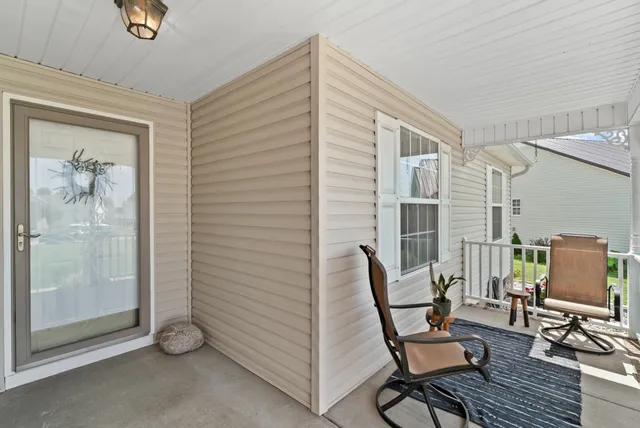 a view of a livingroom with lounge chair and a window