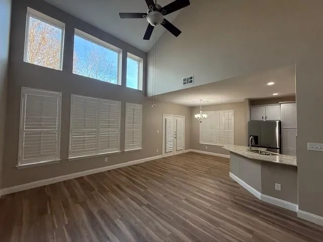 a view of an empty room with a fireplace and a window