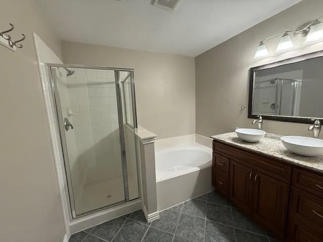 a bathroom with a tub sink shower and mirror