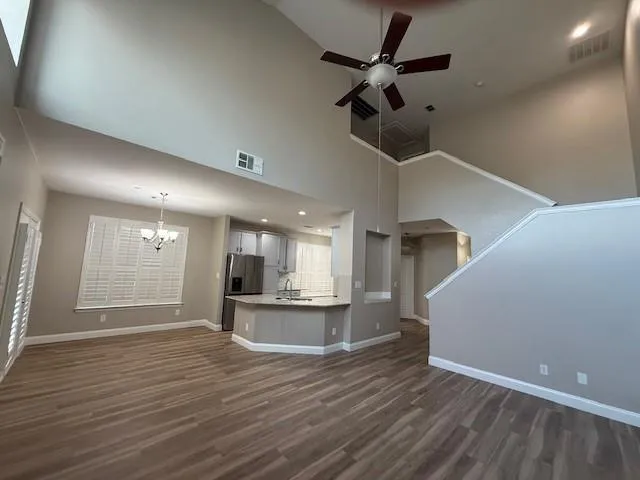 wooden floor in an empty room with a kitchen