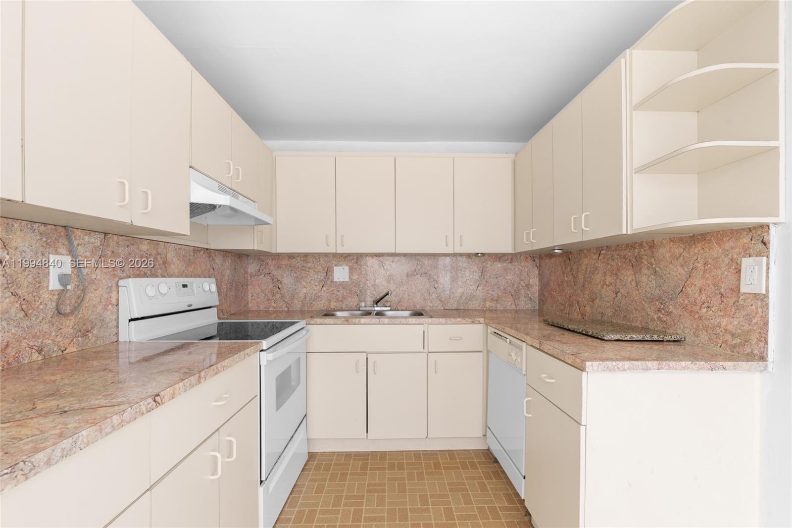 14250 Southwest 62nd Street, Unit 402 Miami, FL 33183 - Photo 11 of 25 a kitchen with a sink dishwasher and white cabinets with wooden floor