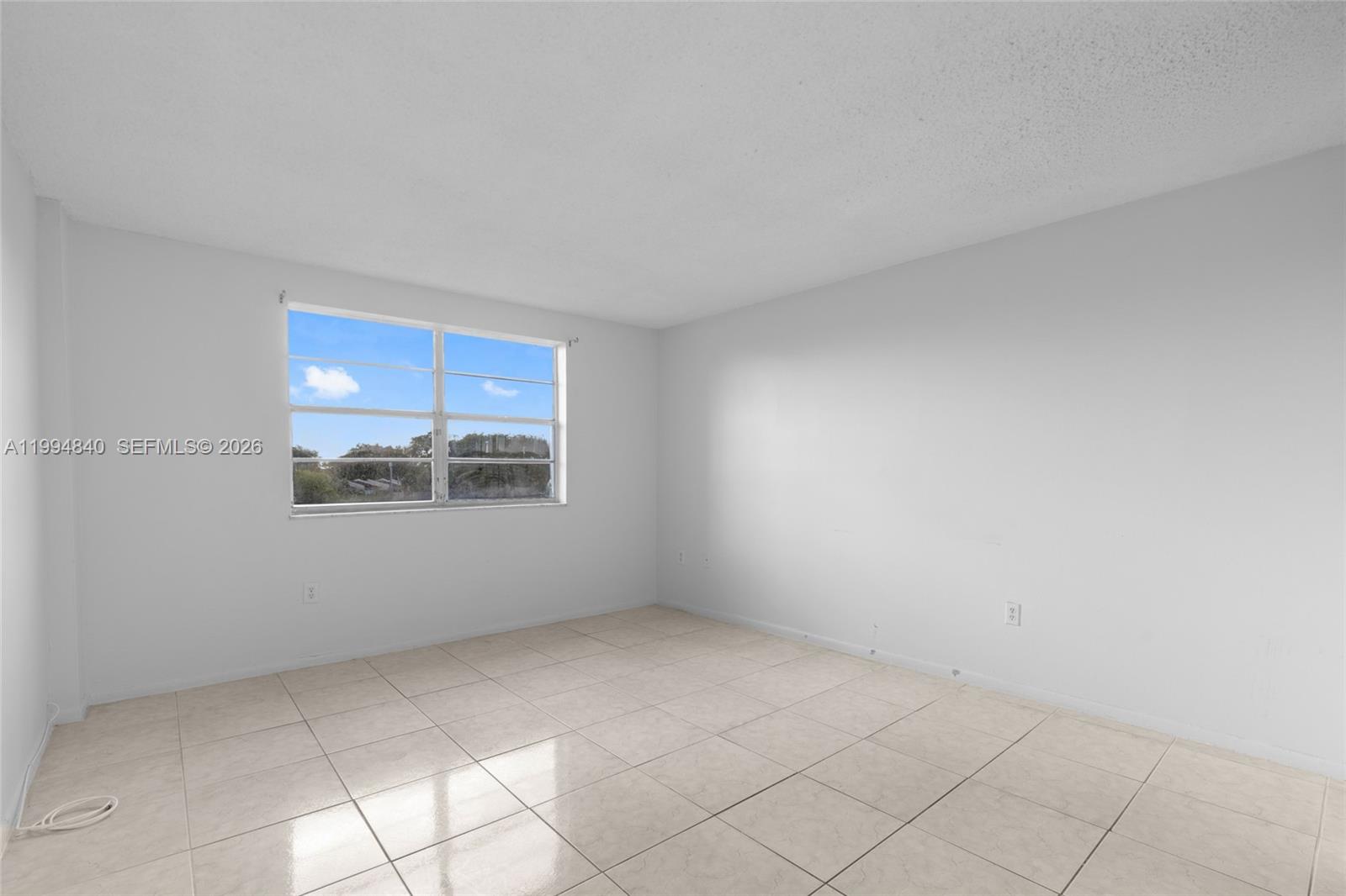 14250 Southwest 62nd Street, Unit 402 Miami, FL 33183 - Photo 13 of 25 a view of an empty room with a window