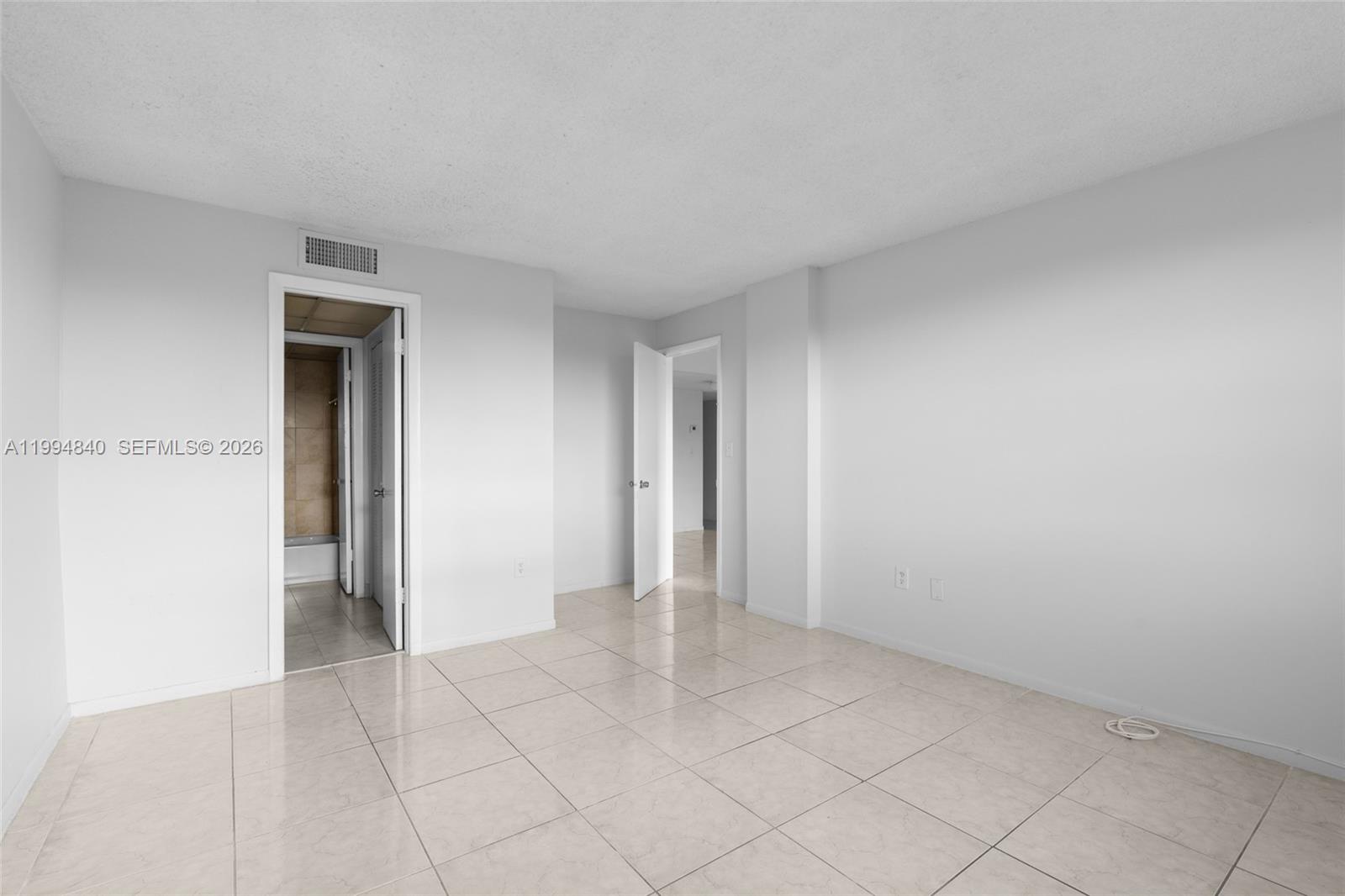 14250 Southwest 62nd Street, Unit 402 Miami, FL 33183 - Photo 14 of 25 an empty room with a natural light