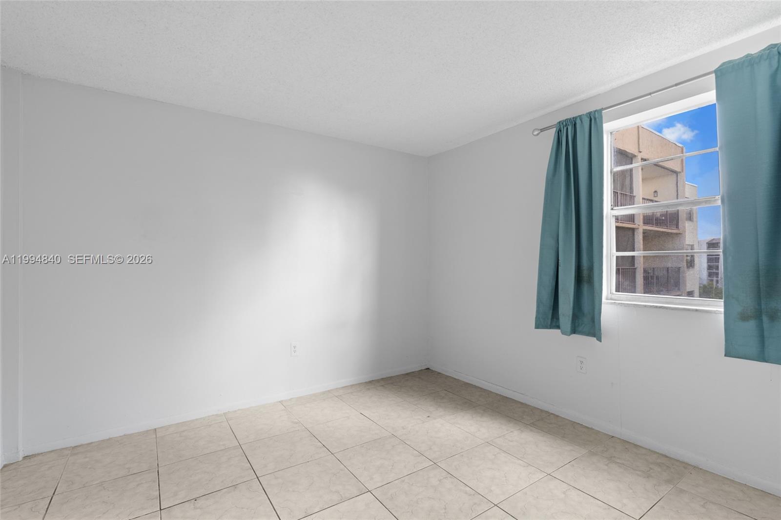 14250 Southwest 62nd Street, Unit 402 Miami, FL 33183 - Photo 17 of 25 an empty room with windows