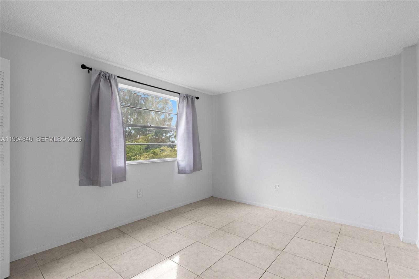 14250 Southwest 62nd Street, Unit 402 Miami, FL 33183 - Photo 18 of 25 an empty room with windows