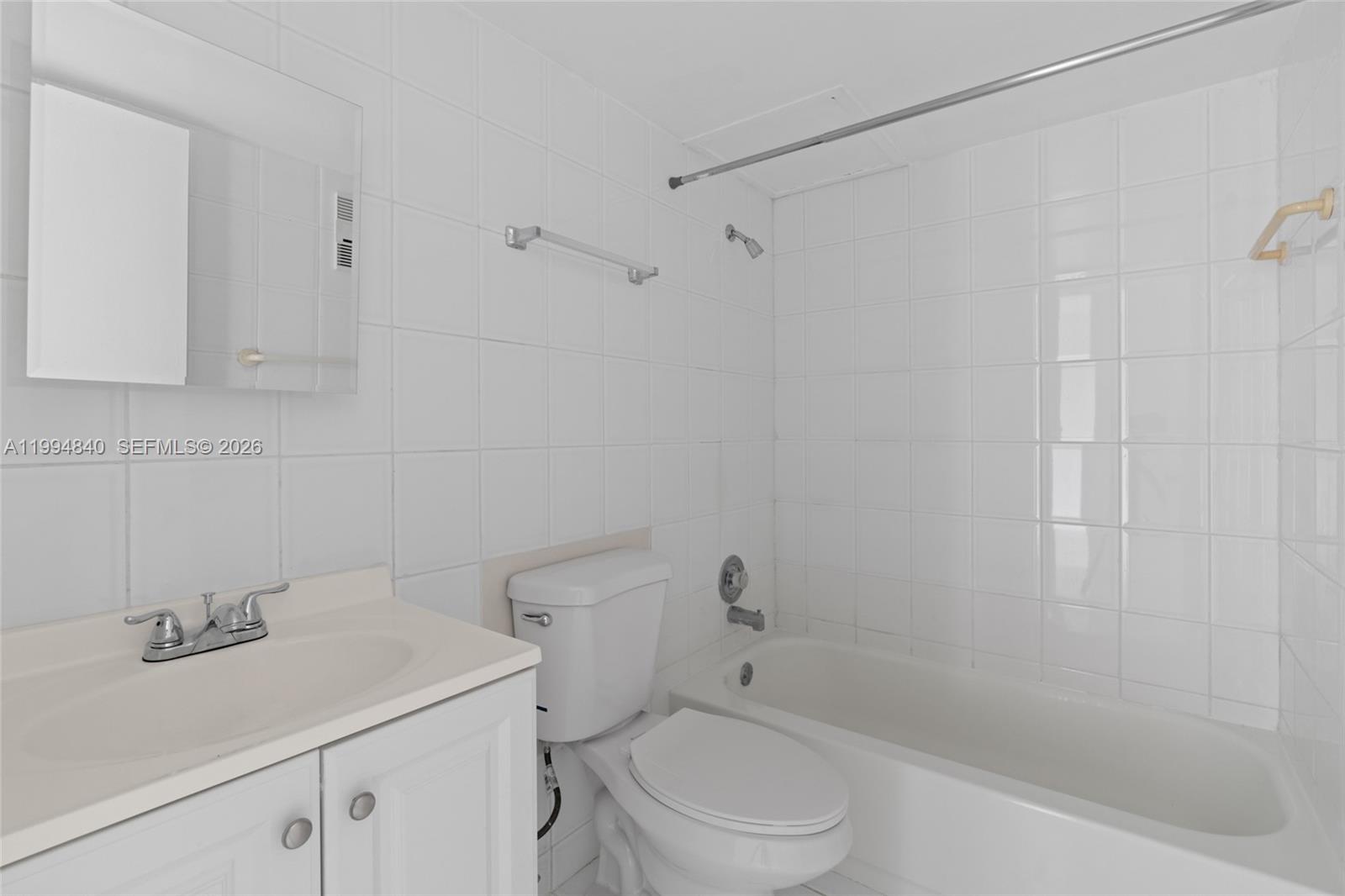 14250 Southwest 62nd Street, Unit 402 Miami, FL 33183 - Photo 19 of 25 a bathroom with a sink a toilet and shower