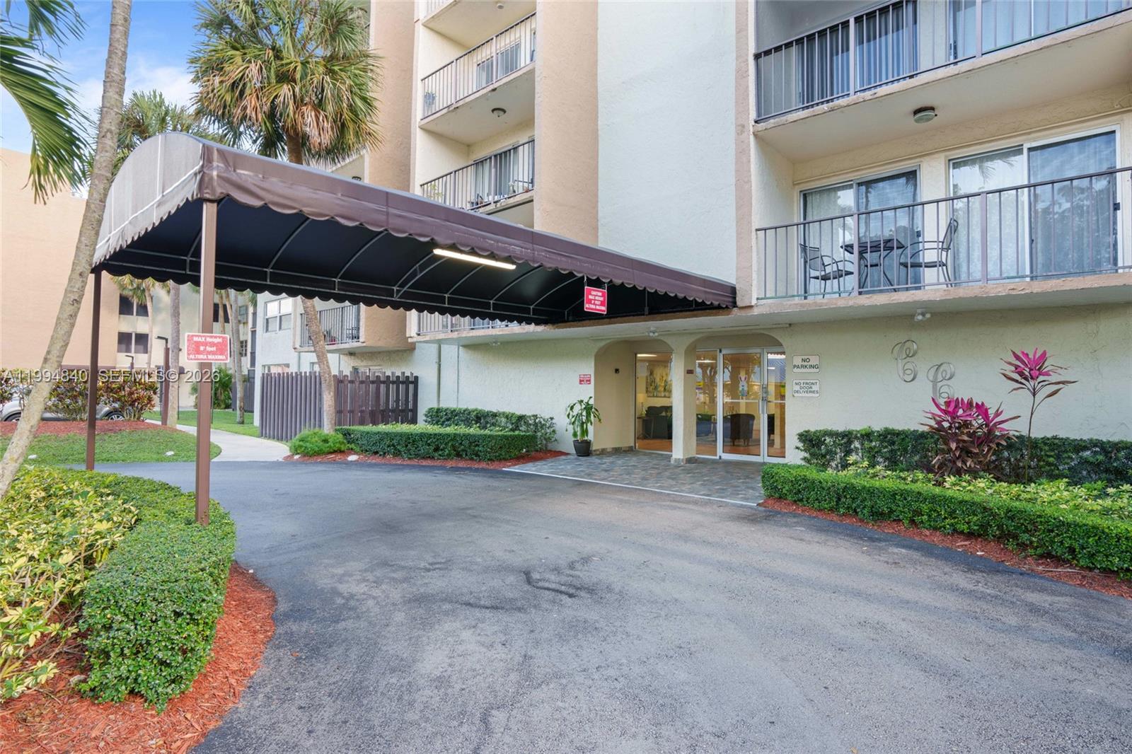 14250 Southwest 62nd Street, Unit 402 Miami, FL 33183 - Photo 4 of 25 a view of a house with a yard and potted plants