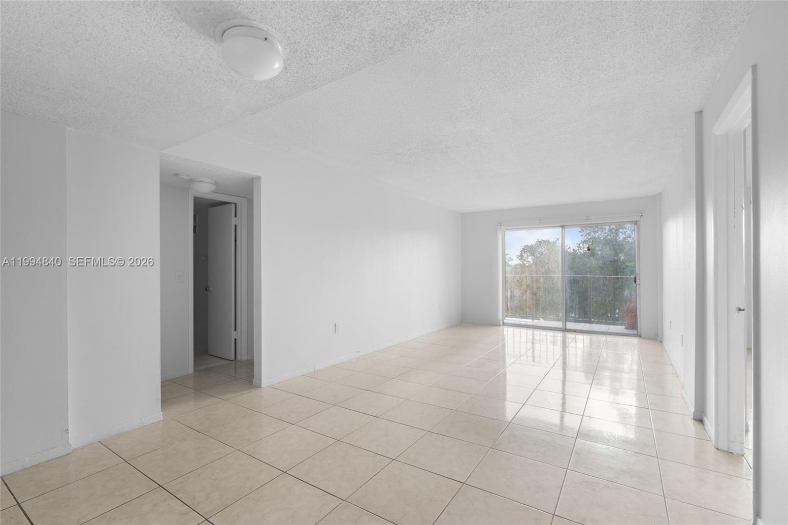 14250 Southwest 62nd Street, Unit 402 Miami, FL 33183 - Photo 7 of 25 an empty room with entrance and windows