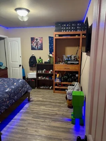 a bedroom with a bed dresser and a window