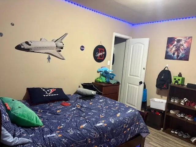 a bedroom with a bed and a chandelier