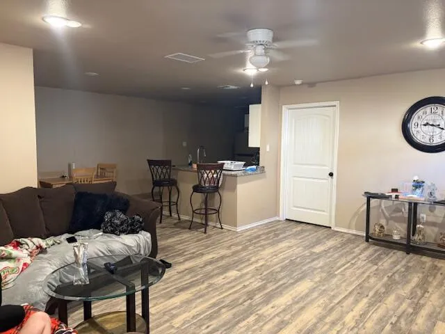 a view of a kitchen with a dining table chairs and a clock on the wall