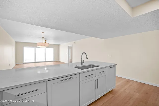 a kitchen with granite countertop a sink and a window