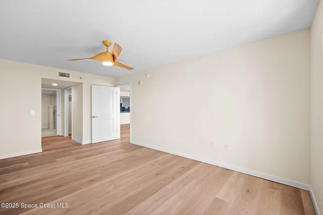 a view of a hallway view with wooden floor and staircase