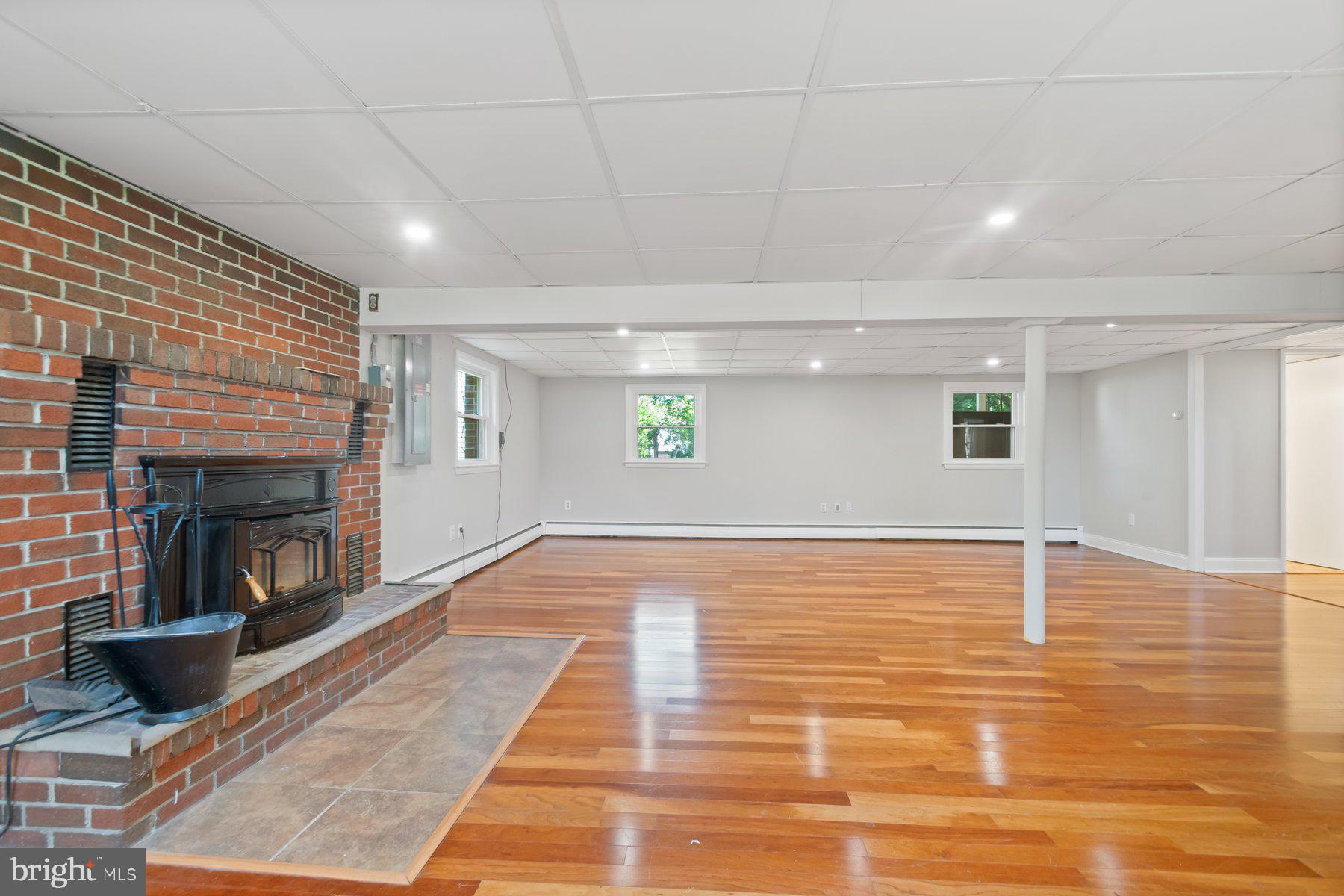 4945 Montgomery Road Ellicott City, MD 21043 - Photo 23 of 37 Lower level rec room with heatilator fireplace