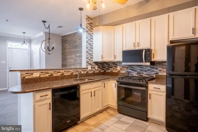 a kitchen with a sink stove and refrigerator