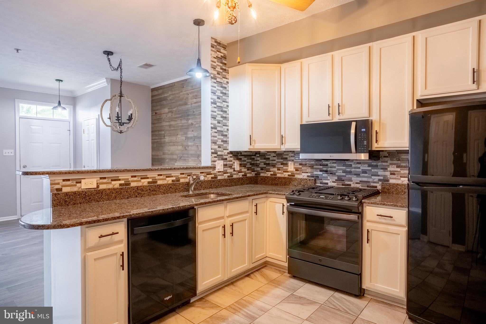 4910 Edgeware Terrace Frederick, MD 21703 - Photo 11 of 34 a kitchen with a sink stove and refrigerator