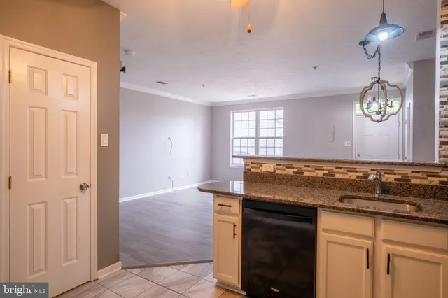 a kitchen with a stove and a chandelier