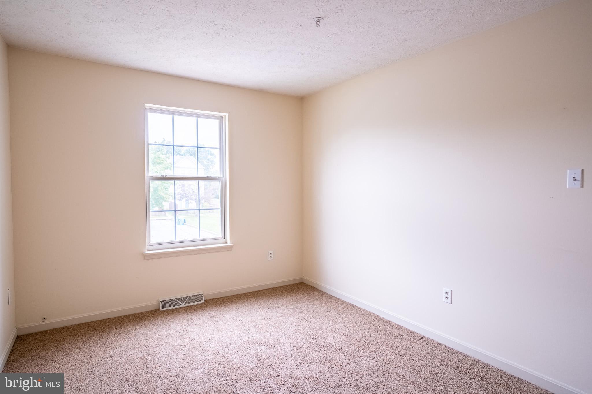 4910 Edgeware Terrace Frederick, MD 21703 - Photo 18 of 34 an empty room with a window