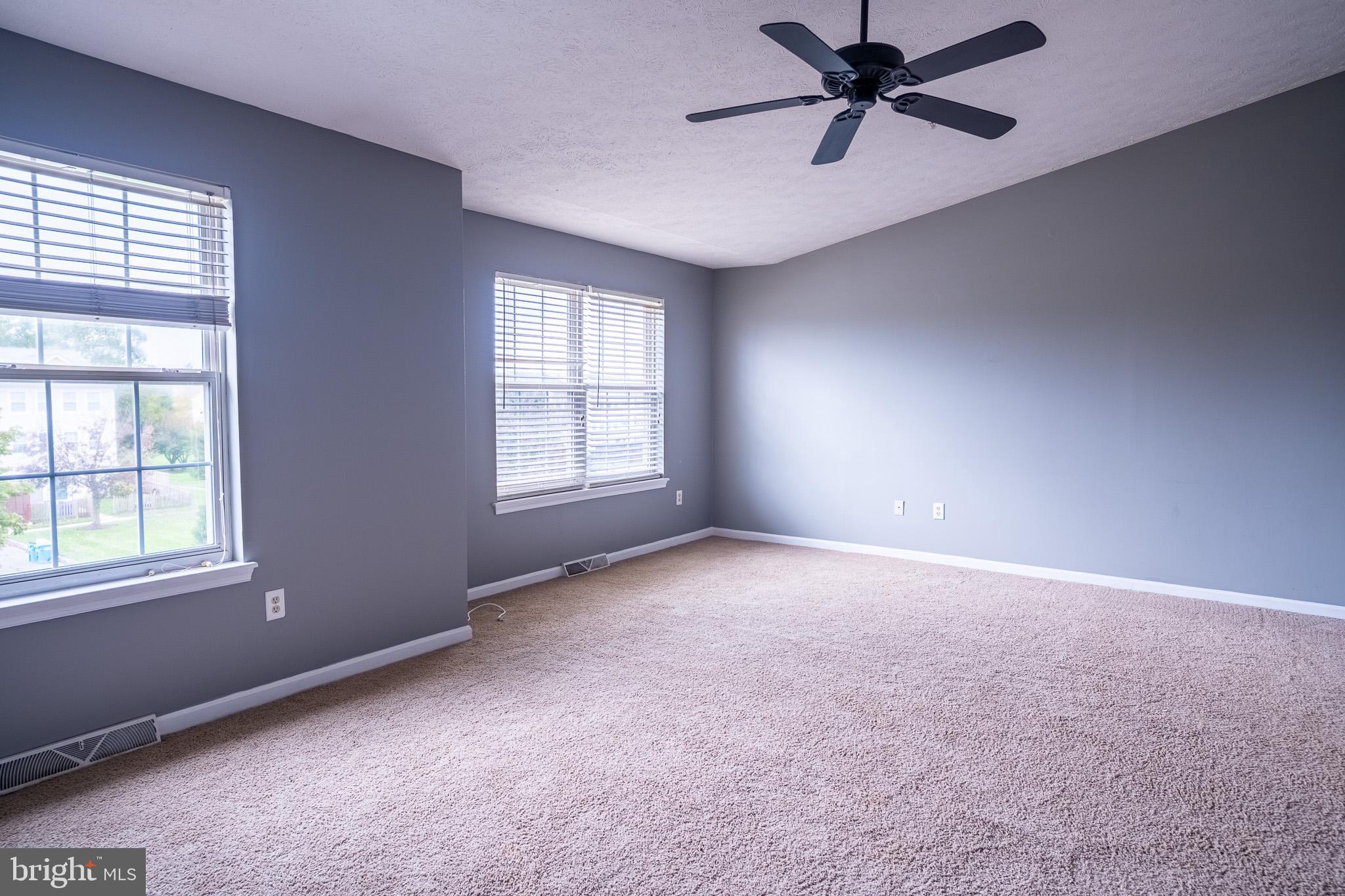 4910 Edgeware Terrace Frederick, MD 21703 - Photo 23 of 34 an empty room with windows and fan
