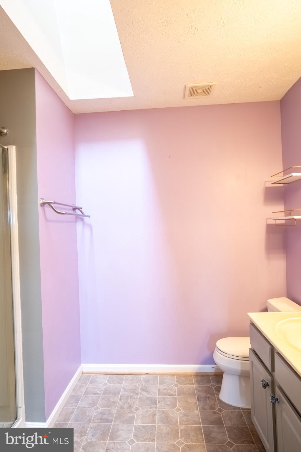 4910 Edgeware Terrace Frederick, MD 21703 - Photo 28 of 34 a bathroom with a granite countertop shower and a toilet