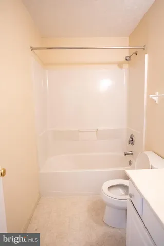 a bathroom with a shower a toilet and a sink