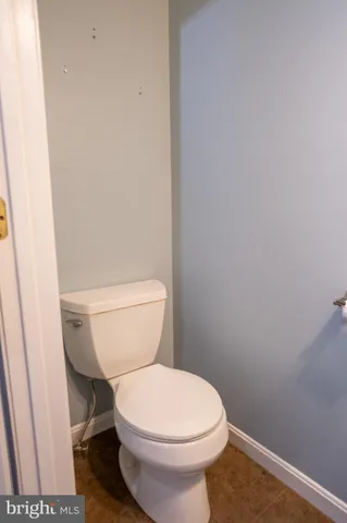 a white toilet sitting next to a shower