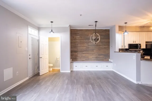 wooden floor in an empty room with a kitchen