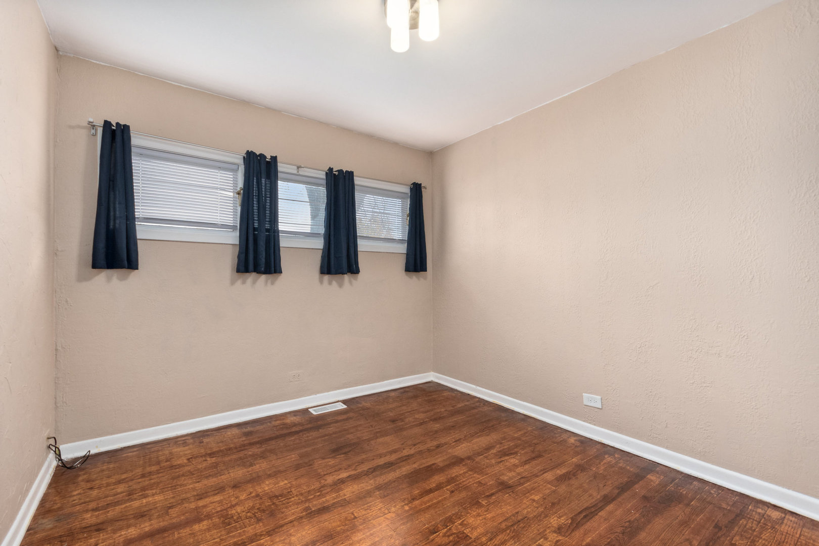 38 Highview Avenue Addison, IL 60101 - Photo 11 of 17 a view of an empty room with wooden floor and window