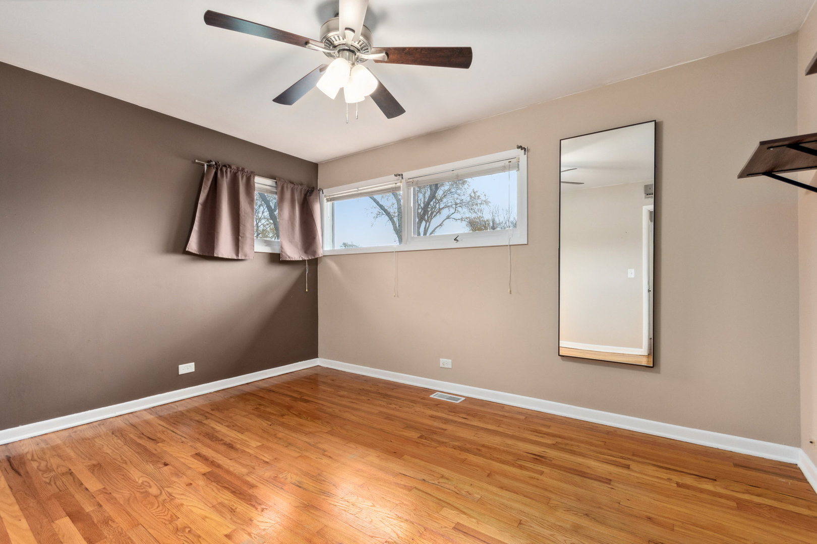 38 Highview Avenue Addison, IL 60101 - Photo 10 of 17 a view of an empty room with window and wooden floor
