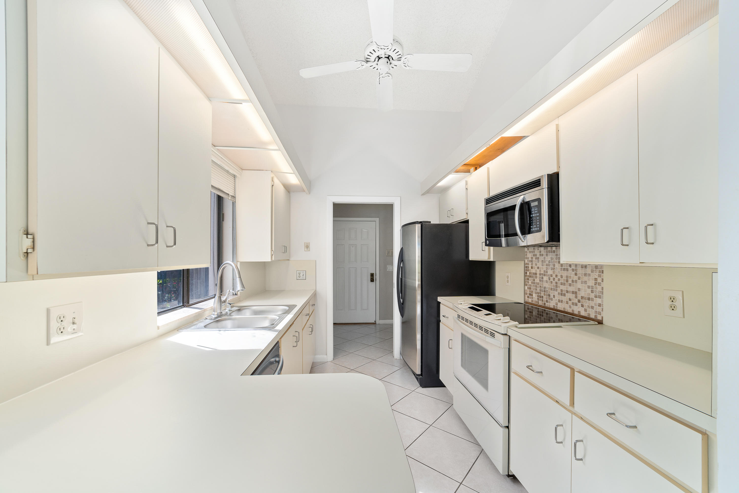 2630 Mohawk Circle West Palm Beach, FL 33409 - Photo 15 of 39 a large white kitchen with stainless steel appliances