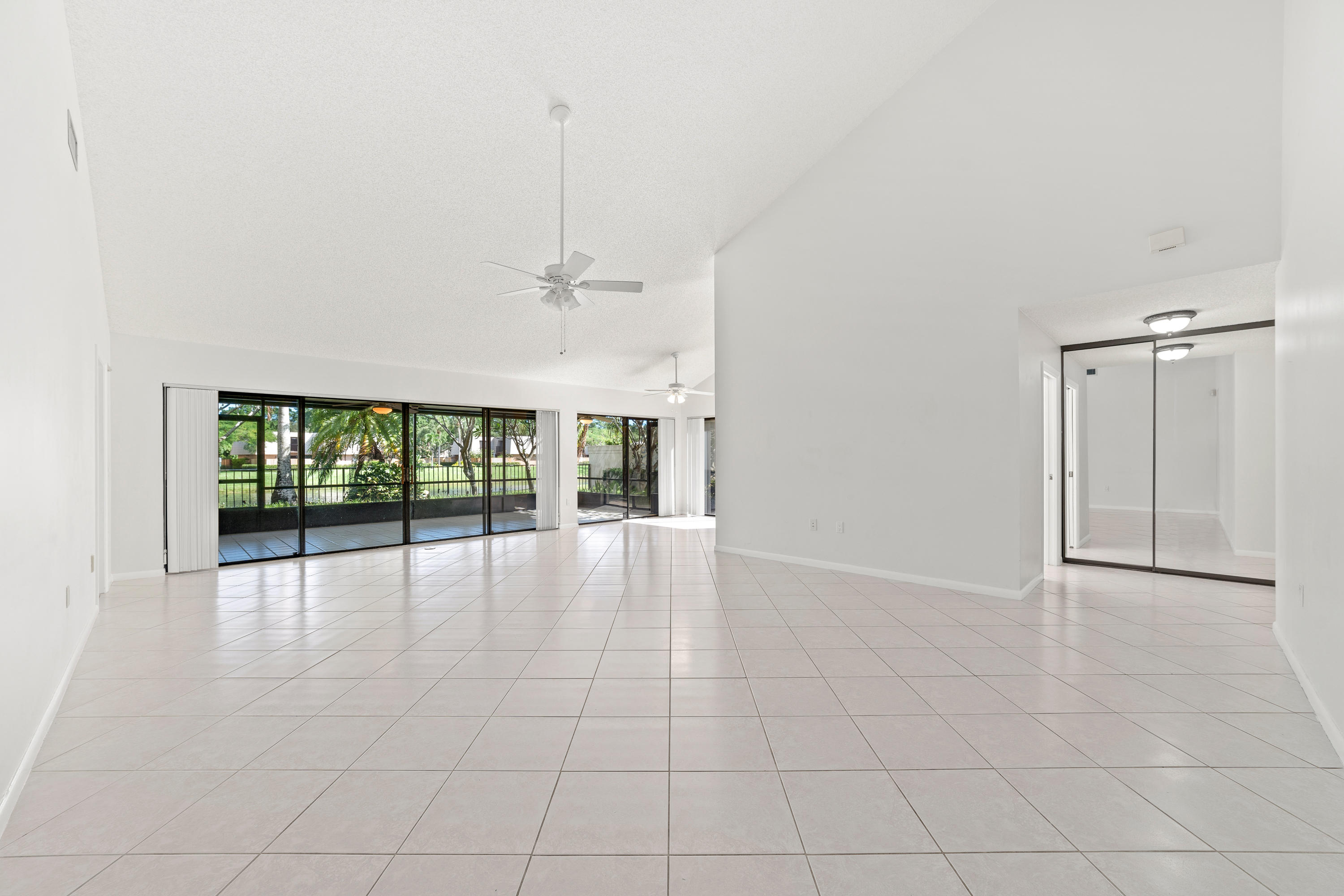 2630 Mohawk Circle West Palm Beach, FL 33409 - Photo 6 of 39 an empty room with floor to ceiling windows and an entryway