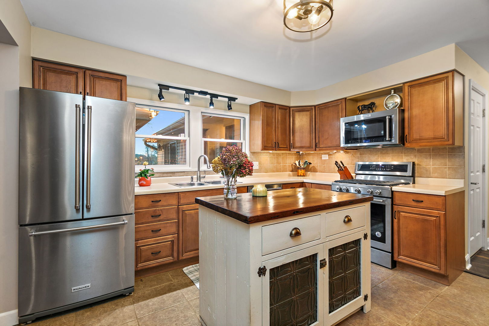 S031 Pearl Road West Chicago, IL 60185 - Photo 6 of 39 a kitchen with stainless steel appliances granite countertop a stove refrigerator sink and a microwave