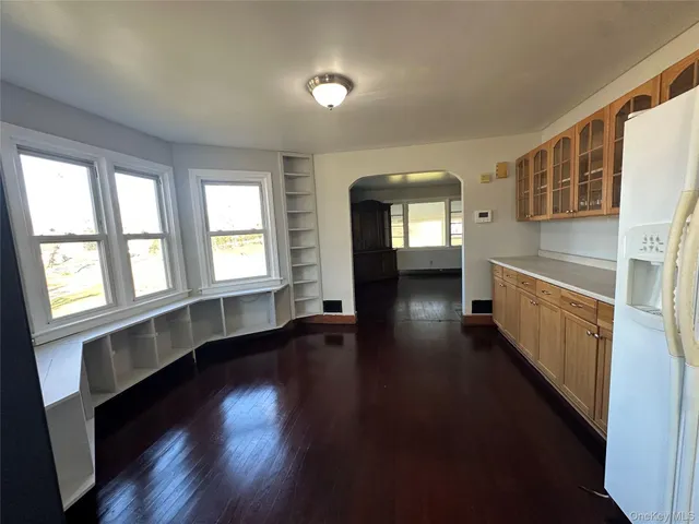 wooden floor in an empty room with a window and wooden floor