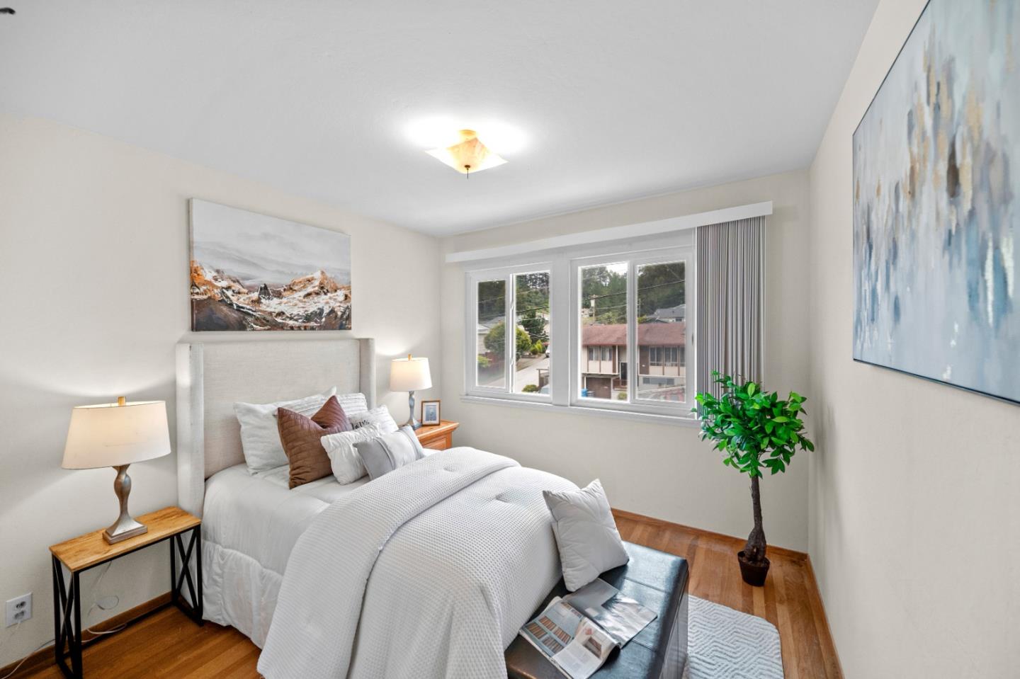 1287 Lerida Way Pacifica, CA 94044 - Photo 36 of 52 a bedroom with a bed lamp and a potted plant