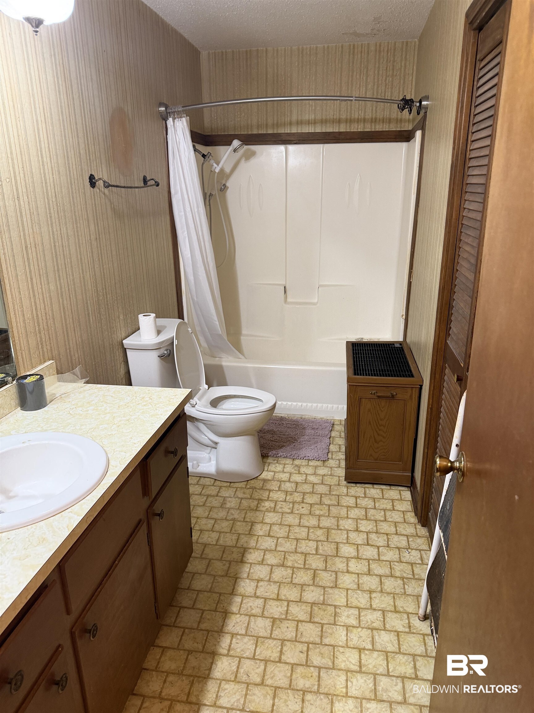 513 Club Wiley Road Jackson, AL 36545 - Photo 15 of 19 Guest Bathroom with vanity, shower / bath combo with shower curtain, a textured ceiling, and a closet