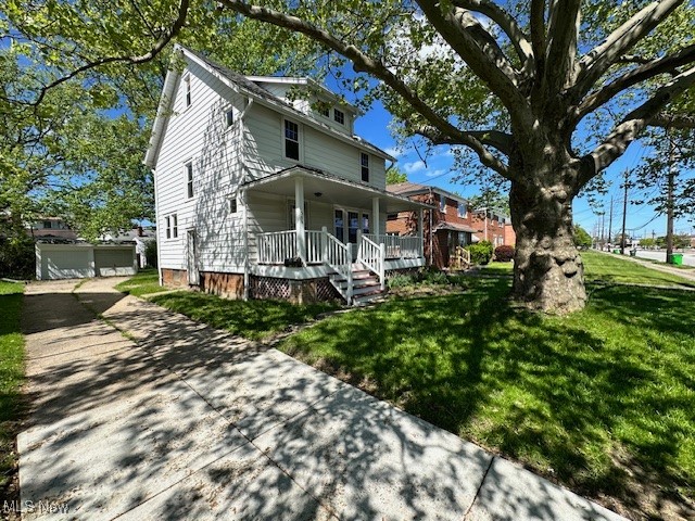356 Babbitt Road Euclid, OH 44123 - Photo 3 of 18 View of front facade with a porch, a front lawn, and an outdoor structure