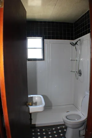 a bathroom with a toilet and a shower