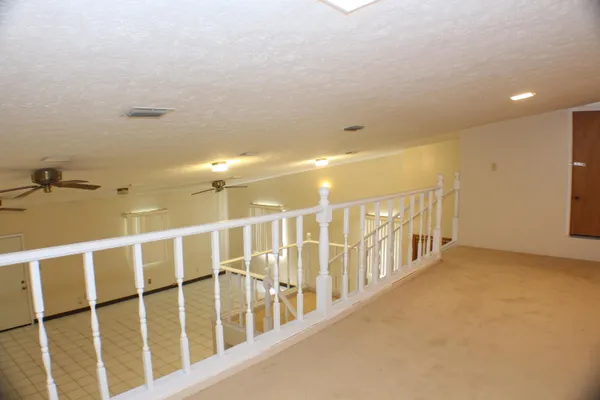 a view of an empty room with windows