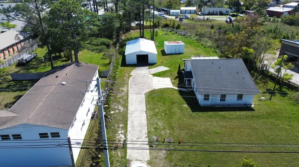 an aerial view of a house with yard swimming pool and outdoor seating