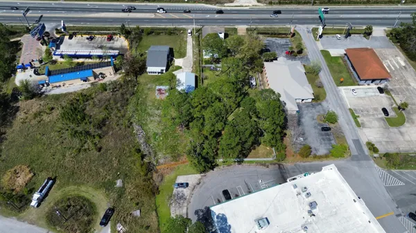 an aerial view of a house with a yard and a fountain