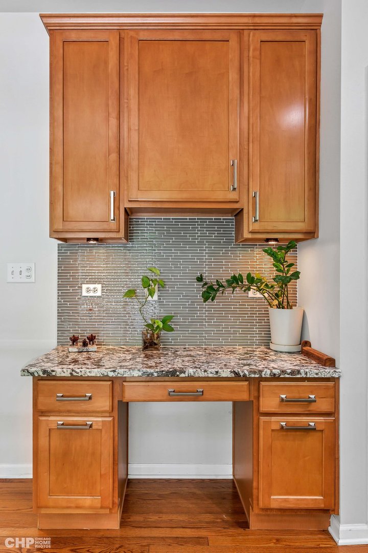 917 Blue Ridge Drive Streamwood, IL 60107 - Photo 11 of 46 a kitchen with granite countertop cabinets and wooden floor