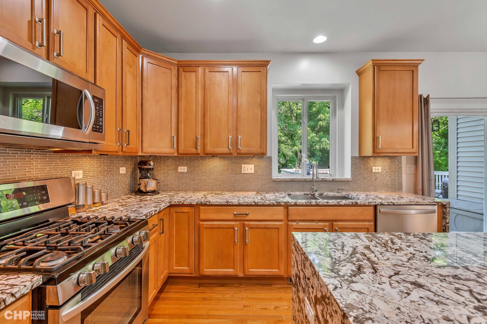 917 Blue Ridge Drive Streamwood, IL 60107 - Photo 10 of 46 a kitchen with stainless steel appliances granite countertop a stove a sink and a microwave
