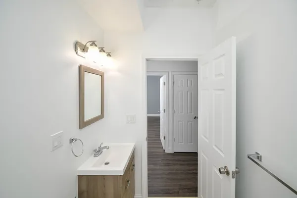 a bathroom with a sink a mirror and vanity