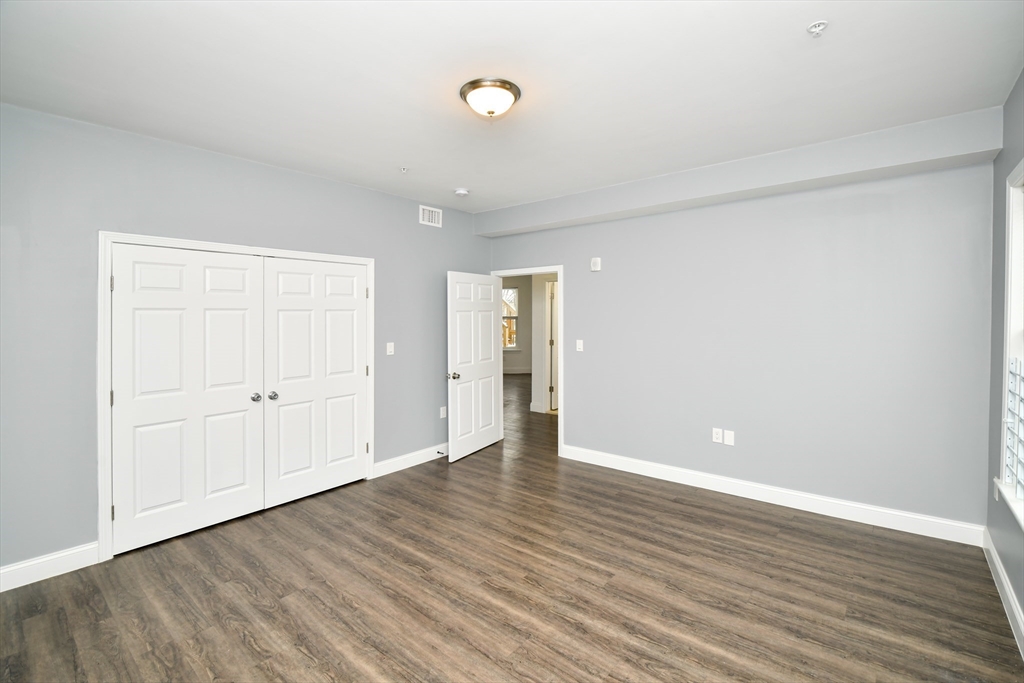55 Dale Street, Unit 3 Boston, MA 02119 - Photo 12 of 24 a view of an empty room with wooden floor