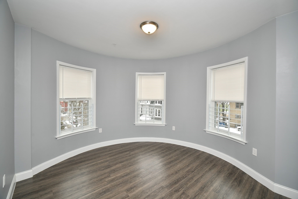 55 Dale Street, Unit 3 Boston, MA 02119 - Photo 18 of 24 a view of an empty room with windows