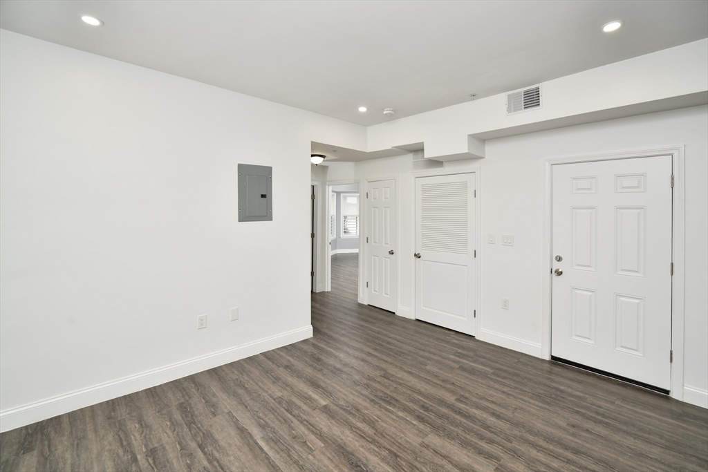 55 Dale Street, Unit 3 Boston, MA 02119 - Photo 9 of 24 a view of an empty room with wooden floor