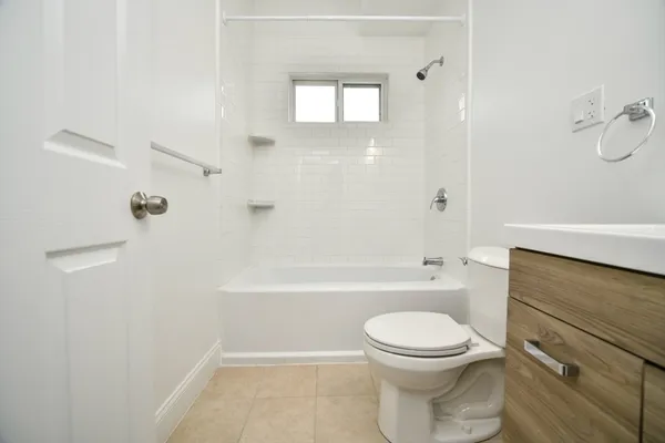 a bathroom with a toilet and a bathtub