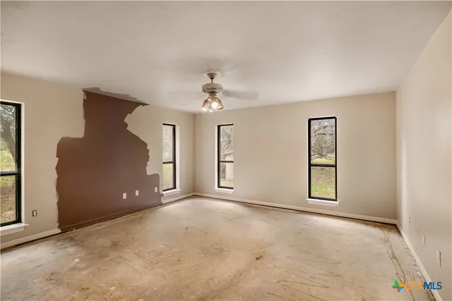 an empty room with windows and closet
