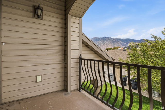 482 South 2500th West, Unit 2 Springville, UT 84663 - Photo 20 of 52 Balcony featuring metal railings, exterior wall sconce, and mountain backdrop