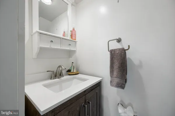 a bathroom with a sink vanity and toilet